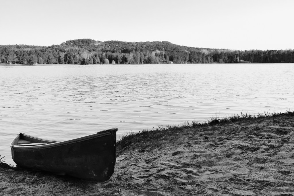 Reflections in Monochrome: A Canoe’s Rest Between Twilight and&nbsp;Dawn